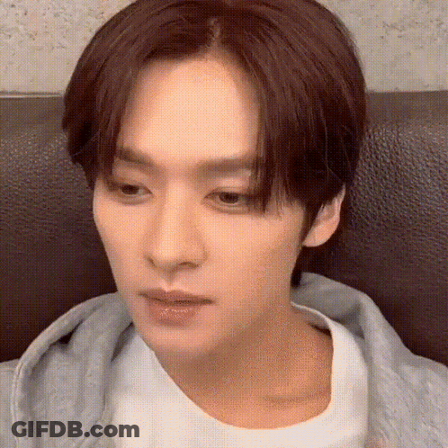 Young Man Sitting On Couch Eyes Closed GIF