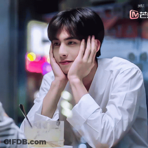 Young Man Sitting With Hand On Face GIF