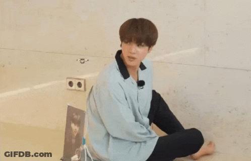 Young Man Sitting With Question Mark GIF