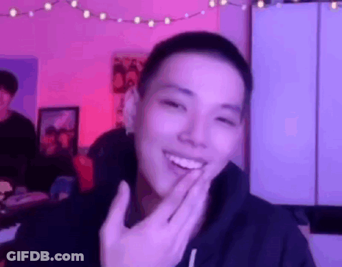 Young Man Smiling Covering Mouth GIF