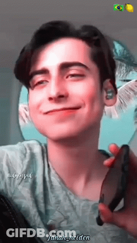Young Man Smiling Holding Cell Phone Janah Helden GIF