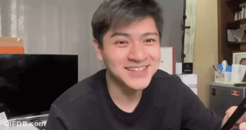Young Man Smiling Holding Cell Phone GIF