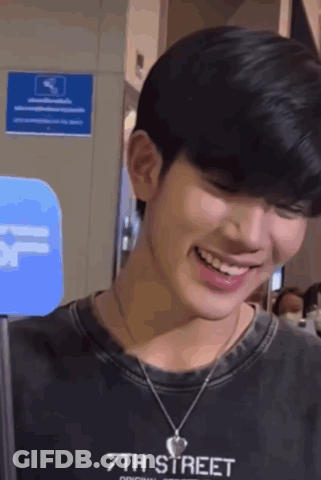 Young Man Smiling In Black 7Th Street Shirt GIF