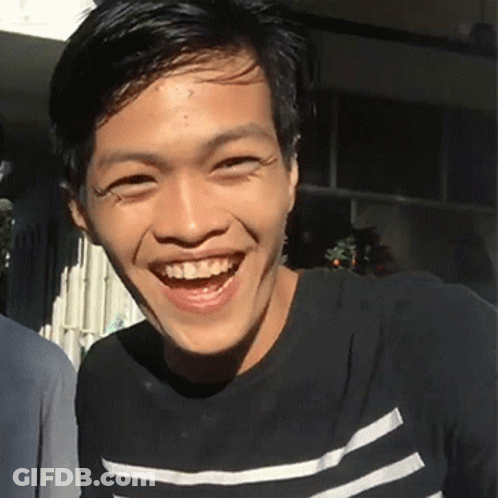 Young Man Smiling In Black And White Stripes GIF