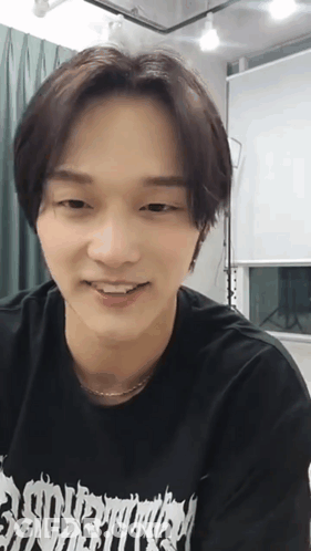 Young Man Smiling In Black Eternity Shirt GIF