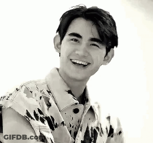 Young Man Smiling In Camouflage Jacket GIF