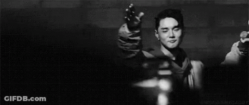 Young Man Smiling In Dark Room GIF