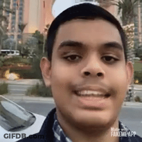 Young Man Smiling In Front Of Car GIF