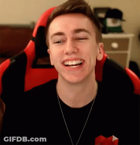 Young Man Smiling In Red And Black Chair GIF