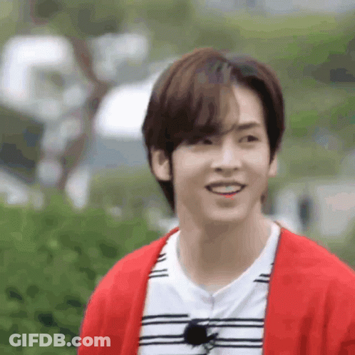 Young Man Smiling In Red Cardigan And Striped Shirt GIF