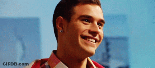 Young Man Smiling On Blue Background GIF