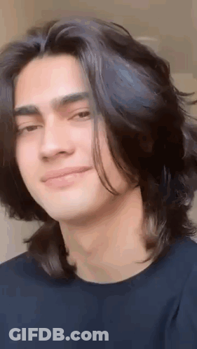 Young Man Smiling With Long Black Hair GIF