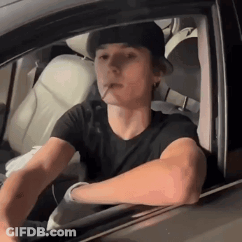 Young Man Smoking Cigarette In Car GIF