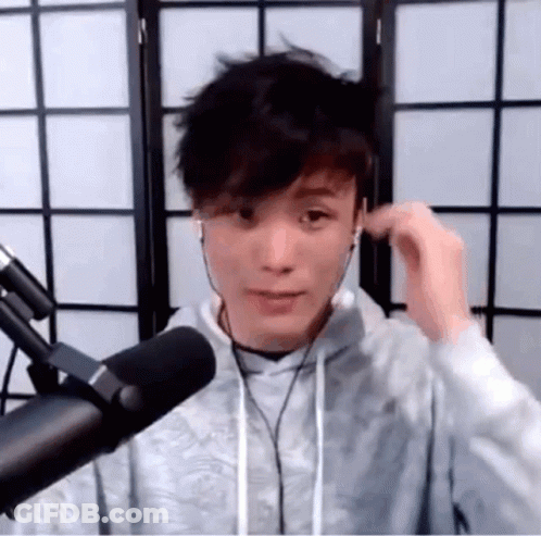 Young Man Standing At Microphone With Headphones GIF