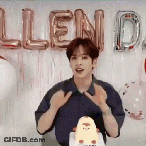 Young Man Standing Before Cake And Balloons GIF