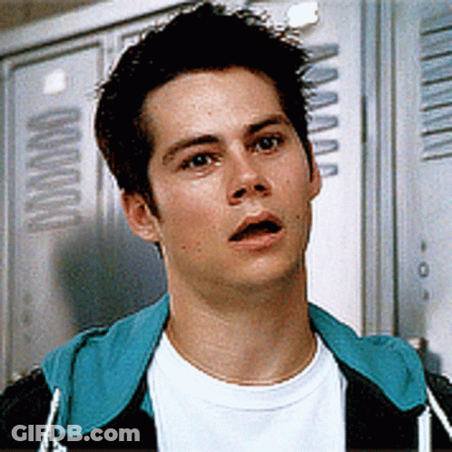 Young Man Standing In Front Of Lockers With Letter A GIF