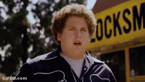 Young Man Standing In Front Of Yellow School Bus GIF