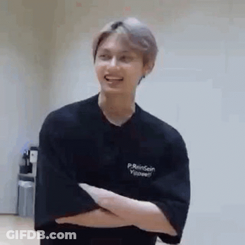 Young Man Standing With Crossed Arms GIF