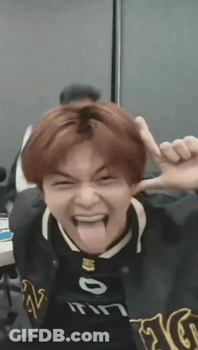 Young Man Sticking Tongue Out In Black Jacket GIF