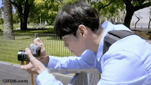 Young Man Taking Picture With Camera GIF