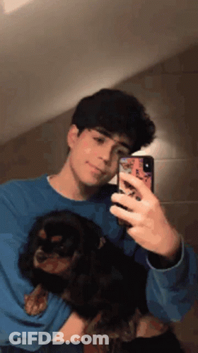 Young Man Taking Selfie Holding Dog GIF
