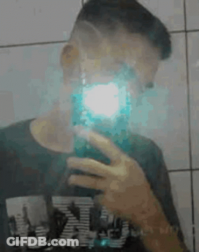Young Man Taking Selfie In Mirror GIF