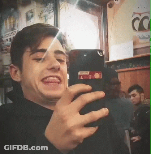 Young Man Taking Selfie With Coca Cola Sign GIF