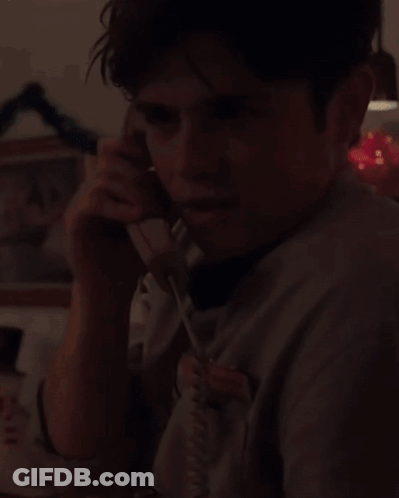 Young Man Talking On Phone With Chris Name Tag GIF
