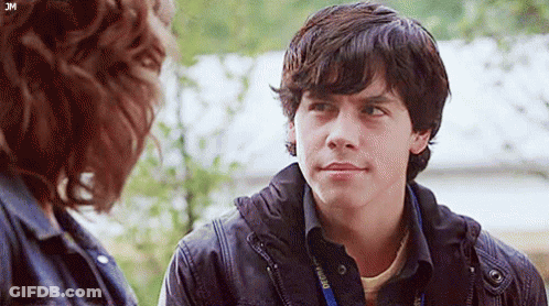 Young Man Talking To Woman With Lanyard GIF