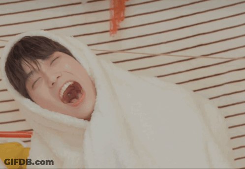 Young Man Under Blanket With Mouth Open GIF