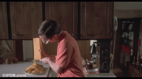 Young Man Using Green And White Blender To Slice Vegetables GIF