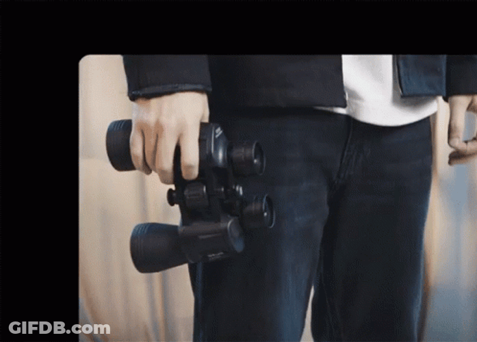 Young Man Using High Resolution Binoculars GIF