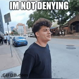 Young Man Walking Down Street Saying Im Not Denying GIF