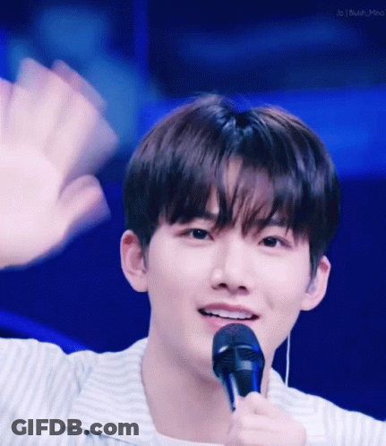 Young Man Waving And Smiling With Microphone GIF