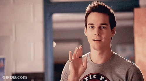 Young Man Waving In Kitchen GIF