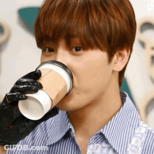Young Man Wearing Black Glove Drinking From Cup GIF