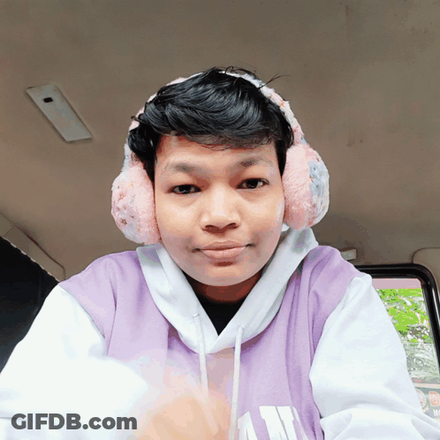 Young Man Wearing Ear Muffs And Purple Hoodie GIF