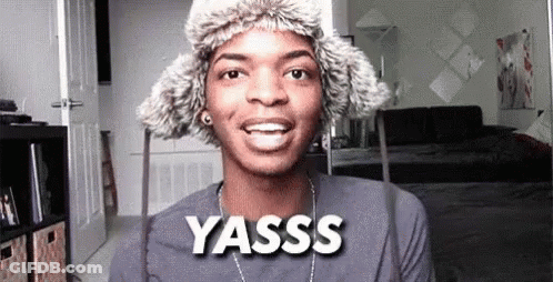 Young Man Wearing Fur Hat And Yasss Necklace GIF