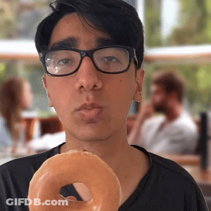 Young Man Wearing Glasses Holding Donut GIF