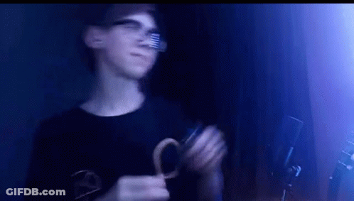 Young Man Wearing Glasses Holding Scissors GIF