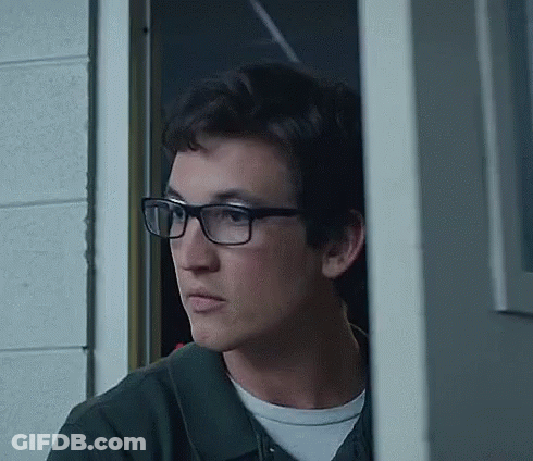 Young Man Wearing Glasses Standing In Doorway GIF