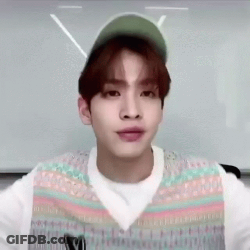 Young Man Wearing Hat And Vest Making Face GIF