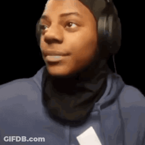 Young Man Wearing Headphones And Blue Hoodie Looking At Camera GIF