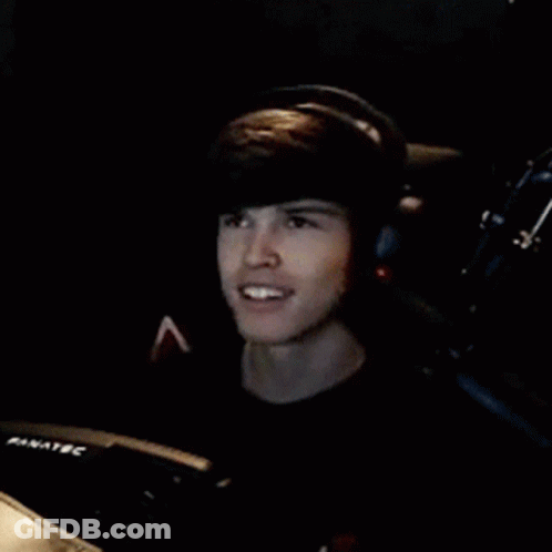 Young Man Wearing Headphones And Smiling In Chair GIF