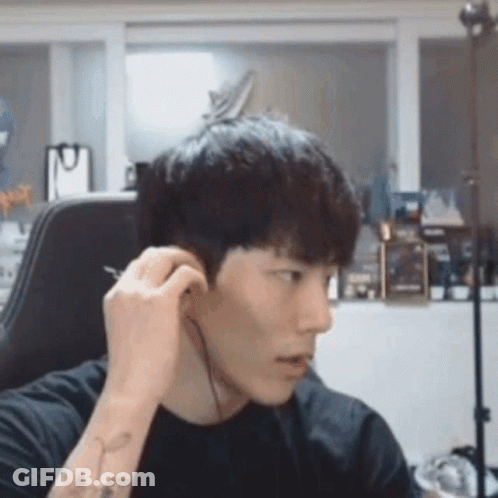 Young Man Wearing Headphones Sitting In Chair GIF