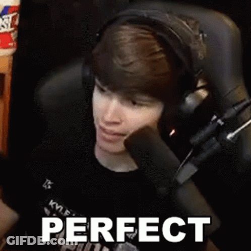 Young Man Wearing Headphones Sitting In Front Of Microphone Making A Face GIF