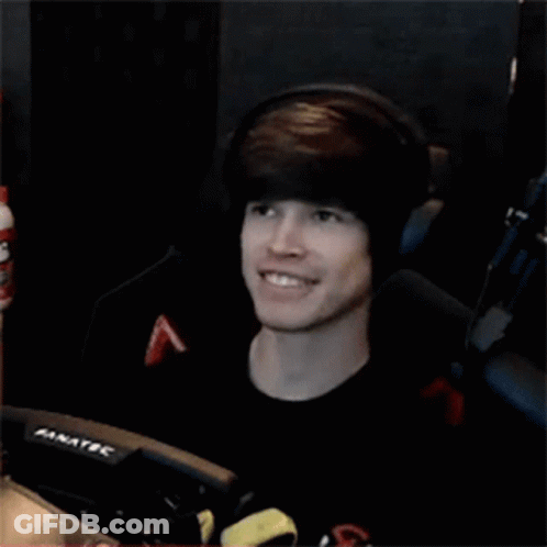 Young Man Wearing Headphones Smiling In Front Of Fanatec Monitor GIF