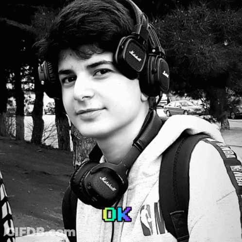 Young Man Wearing Marshall Headphones And Backpack GIF