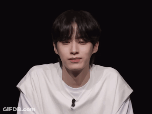 Young Man Wearing White T-Shirt With Microphone GIF