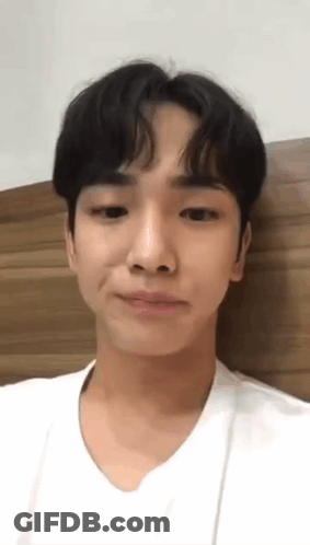 Young Man White Shirt Making Funny Face Against Wall GIF